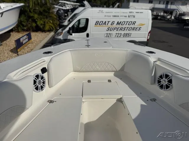 Slide: The Image of 2025 Key West 263 FS boat interior with white seating and storage compartments. - 37