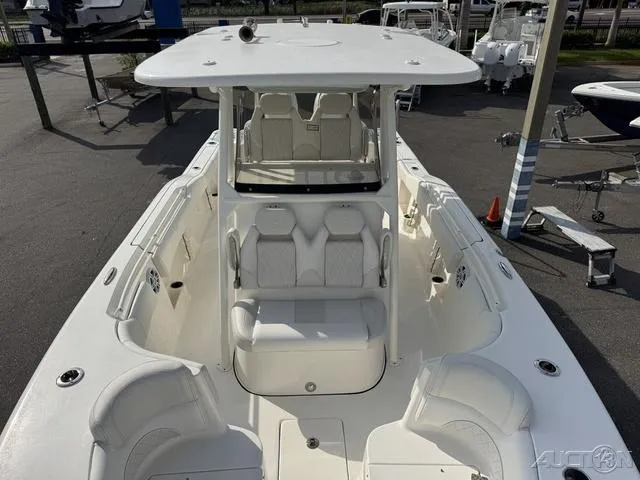 Slide: The Image of 2025 Key West 263 FS boat, white interior, spacious seating, docked at marina. - 39