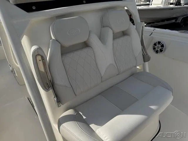 Slide: The Image of 2025 Key West 263 FS boat seat with cushioned armrests and diamond-pattern upholstery. - 43