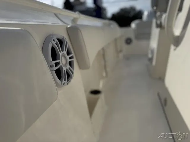 Slide: The Image of 2025 Key West 263 FS boat interior with seating and console, parked outdoors. - 46