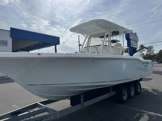 Slide: The Image of 2025 Key West 263 FS boat on trailer under cloudy sky. - 5
