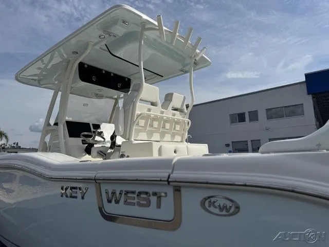 Slide: The Image of 2025 Key West 263 FS boat with dual outboard engines, parked outdoors. - 7