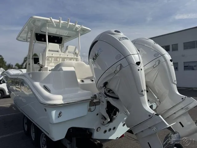 Slide: The Image of 2025 Key West 263 FS boat with dual Yamaha 200 engines, docked outdoors. - 8