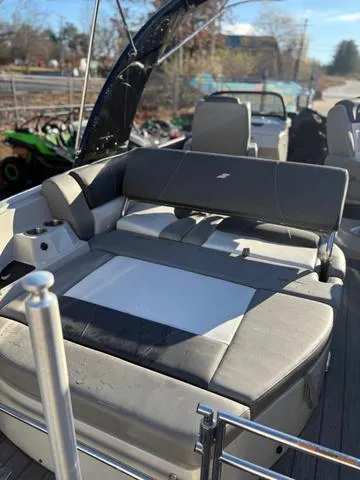 Slide: The Image of 2022 Starcraft MX 25 Q DC Tritoon with trailer, featuring spacious seating and modern design. - 3