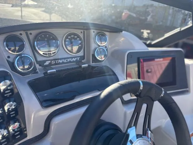 Slide: The Image of Dashboard of 2022 Starcraft MX 25 Q DC Tritoon with steering wheel and gauges. - 5