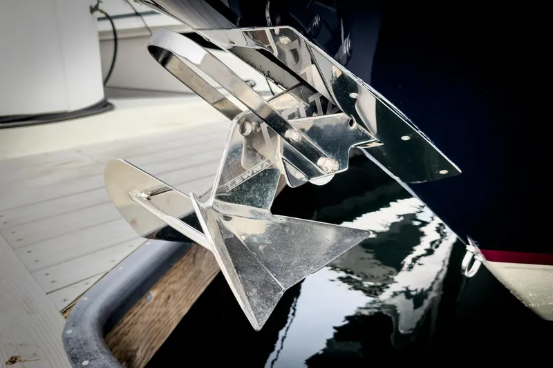 Slide: The Image of Chrome anchor of 2012 Chris-Craft Corsair 28 boat, docked by wooden pier. - 10
