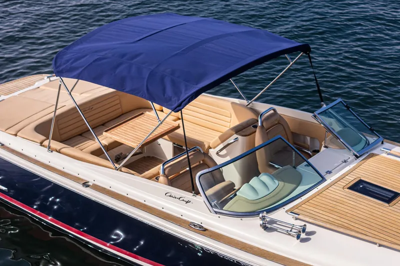Slide: The Image of 2012 Chris-Craft Corsair 28 boat with blue canopy on water. - 13