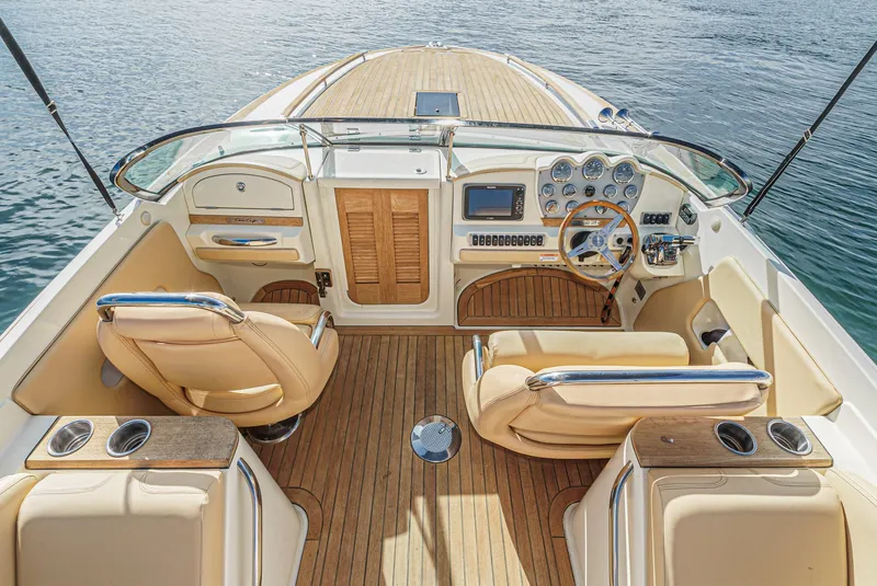 Slide: The Image of Luxurious 2012 Chris-Craft Corsair 28 boat interior with elegant seating and wooden deck. - 14