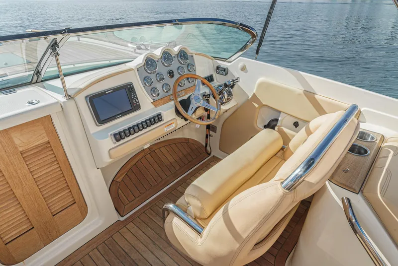 Slide: The Image of 2012 Chris-Craft Corsair 28 cockpit with luxurious seating and modern dashboard controls. - 16
