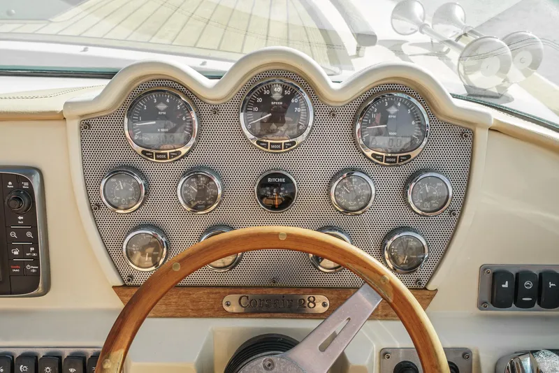 Slide: The Image of 2012 Chris-Craft Corsair 28 dashboard with classic gauges and wooden steering wheel. - 18