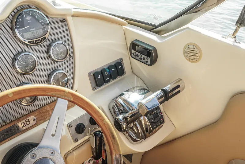 Slide: The Image of Dashboard of a 2012 Chris-Craft Corsair 28 boat with steering wheel and controls. - 19