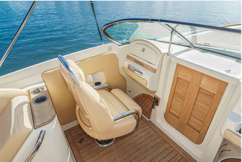 Slide: The Image of 2012 Chris-Craft Corsair 28 interior with beige seating and wooden accents. - 20