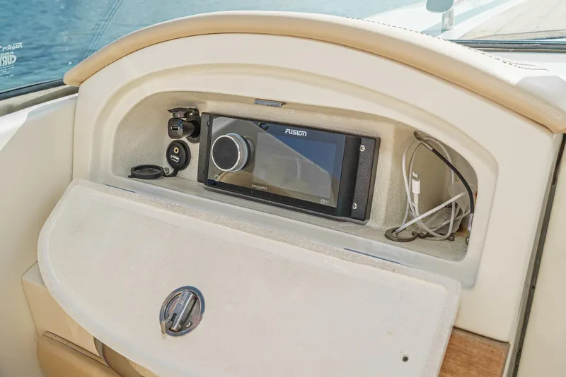 Slide: The Image of 2012 Chris-Craft Corsair 28 dashboard with Fusion stereo system and storage compartment. - 21