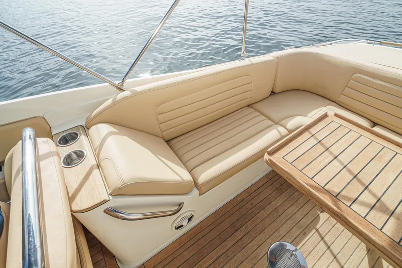 Slide: The Image of Luxurious seating on 2012 Chris-Craft Corsair 28 boat with wooden deck and water view. - 29