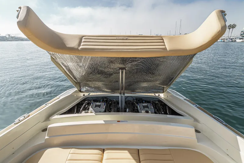 Slide: The Image of 2012 Chris-Craft Corsair 28 boat with open engine compartment on calm water. - 34
