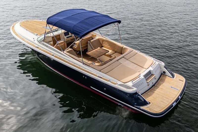 Slide: The Image of 2012 Chris-Craft Corsair 28 boat with blue canopy on calm water. - 4