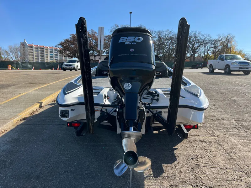 Slide: The Image of 2013 Triton 21 HP boat with 250 Pro engine, parked outdoors. - 14