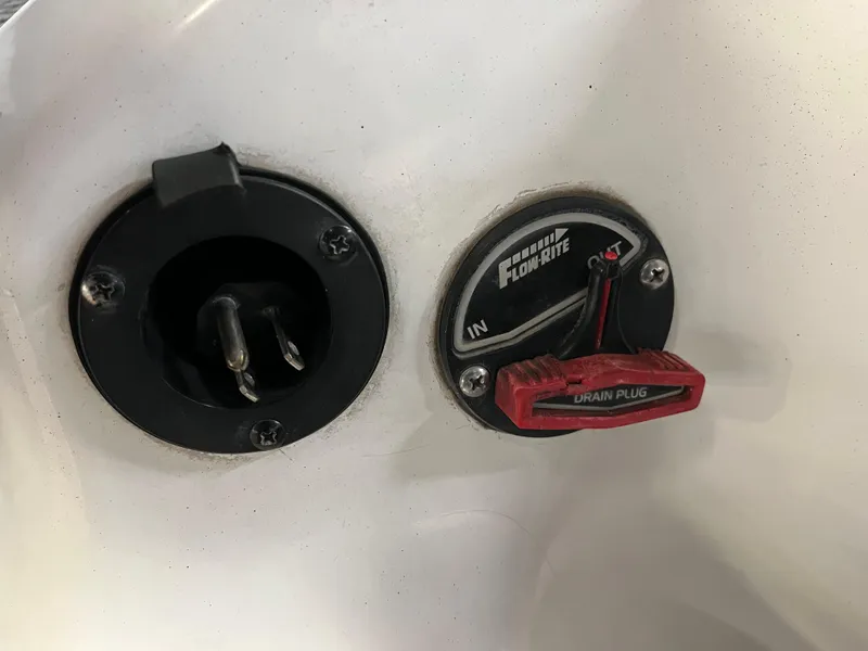 Slide: The Image of Triton 21 HP 2013 boat plug and drain plug controls. - 15