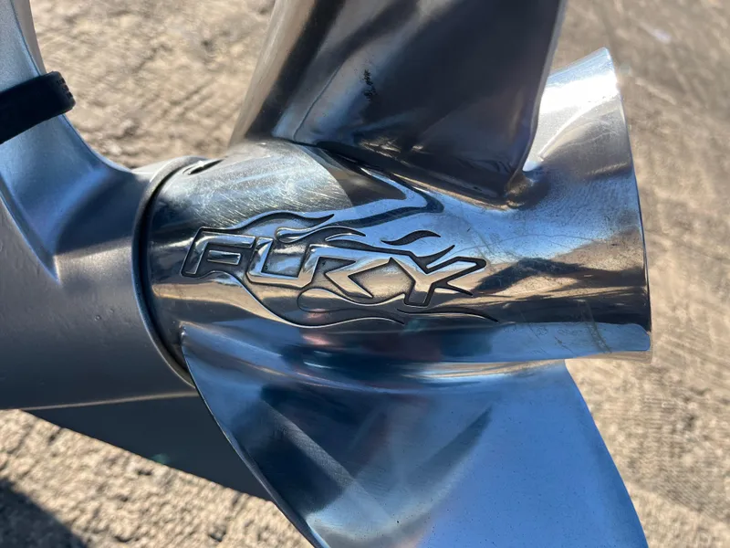 Slide: The Image of Close-up of a 2013 Triton 21 HP boat propeller with "Fury" engraving. - 16