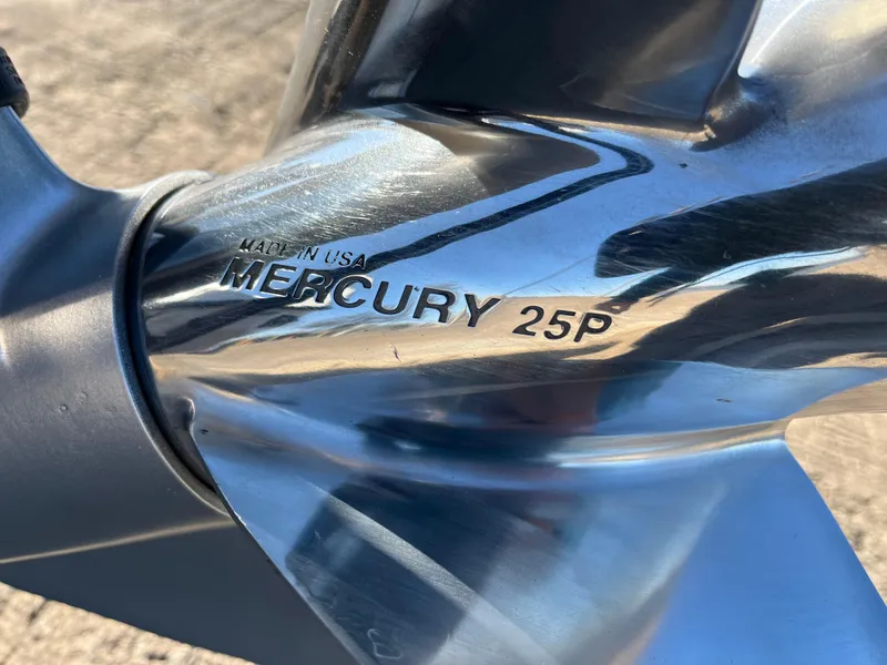 Slide: The Image of Close-up of a Mercury 25P propeller, made in USA, on a 2013 Triton 21 HP boat. - 17