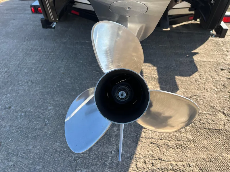 Slide: The Image of Close-up of a 2013 Triton 21 HP boat propeller on a concrete surface. - 18