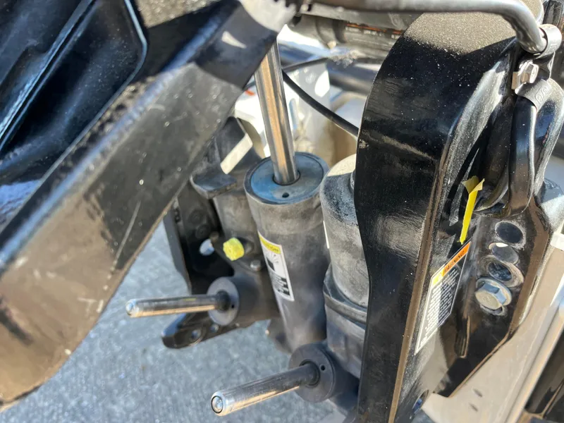 Slide: The Image of Close-up of 2013 Triton 21 HP machinery components, showing hydraulic parts and metal rods. - 19