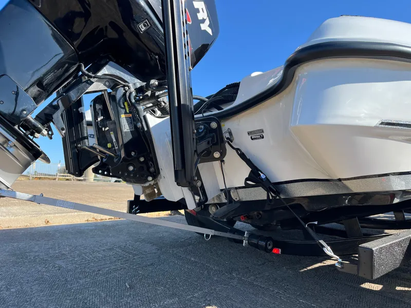 Slide: The Image of 2013 Triton 21 HP boat on trailer, close-up of motor and hull. - 20