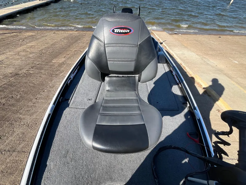 Slide: The Image of 2013 Triton 21 HP boat seat on a docked fishing boat. - 29