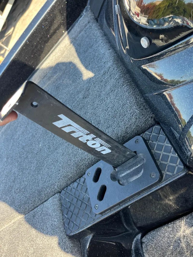 Slide: The Image of 2013 Triton 21 HP boat pedal on textured carpeted floor. - 37