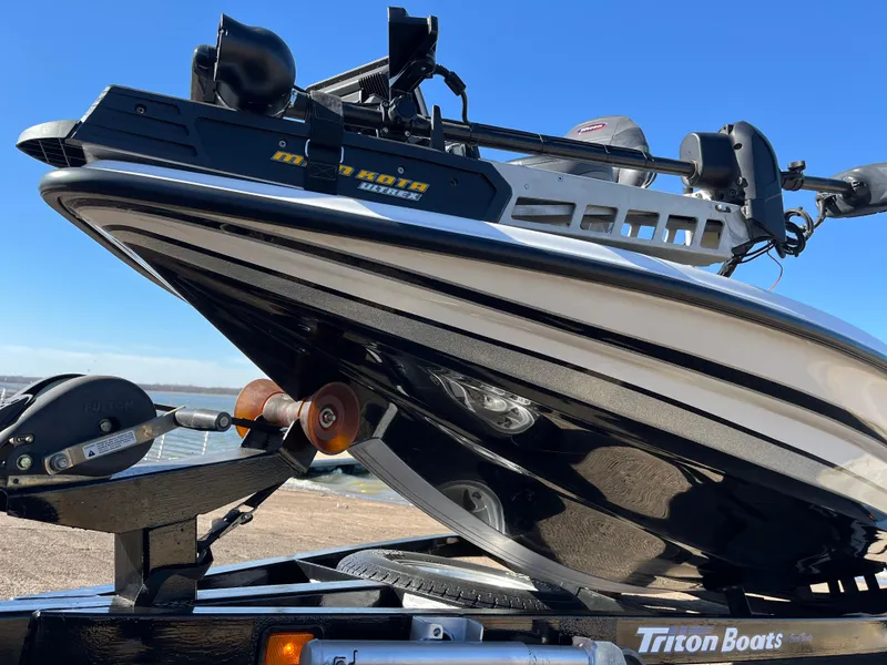 Slide: The Image of 2013 Triton 21 HP boat on trailer, close-up view. - 4