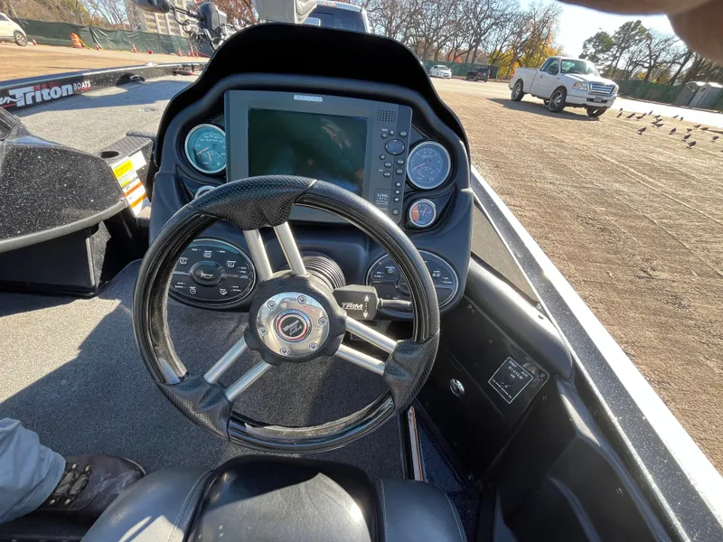 Slide: The Image of 2013 Triton 21 HP boat dashboard with steering wheel and control panel. - 41