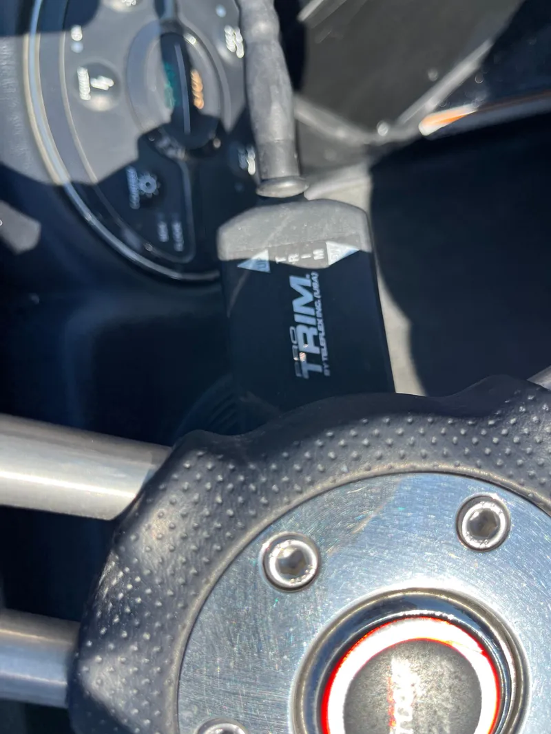 Slide: The Image of Close-up of 2013 Triton 21 HP boat steering wheel and trim control. - 45