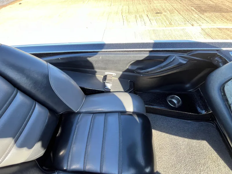 Slide: The Image of 2013 Triton 21 HP boat interior with black leather seats. - 47