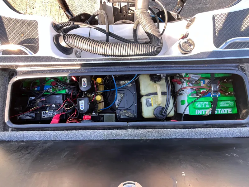 Slide: The Image of 2013 Triton 21 HP boat battery compartment with wiring and Interstate batteries. - 48