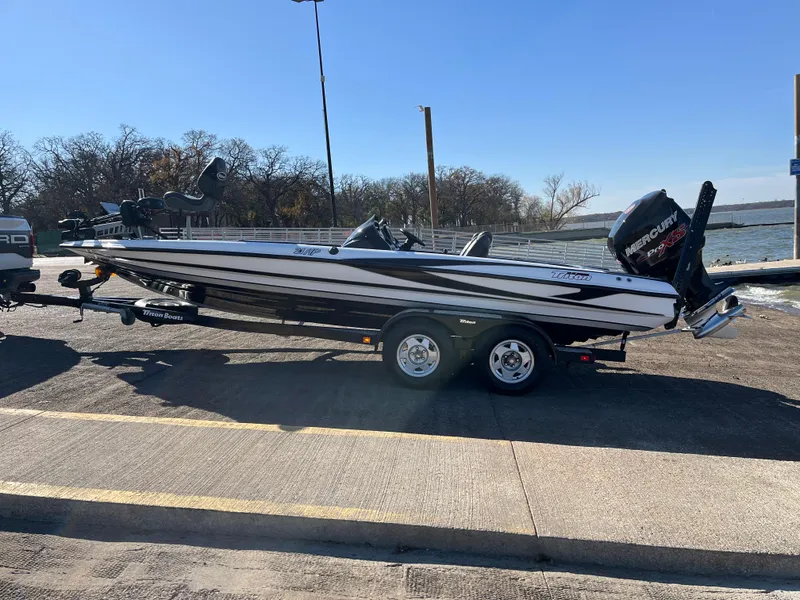 Slide: The Image of 2013 Triton 21 HP boat on trailer by lakeside, ready for launch. - 6