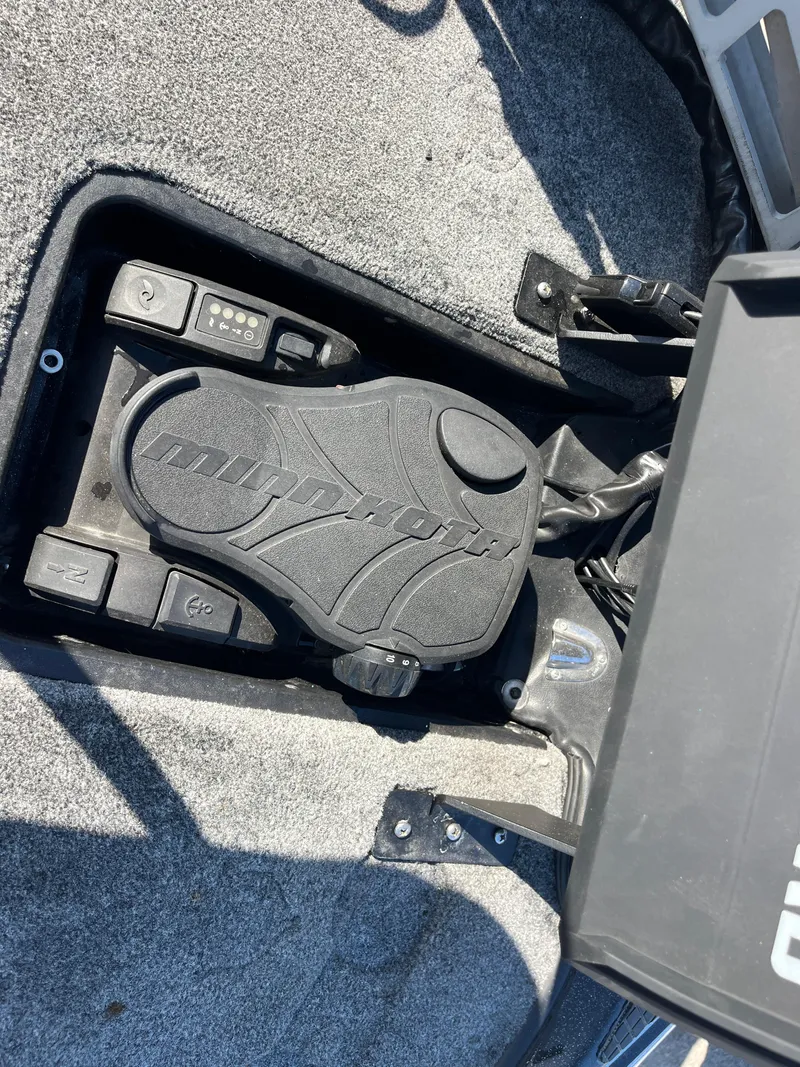 Slide: The Image of Triton 21 HP 2013 boat foot pedal on carpeted floor. - 61