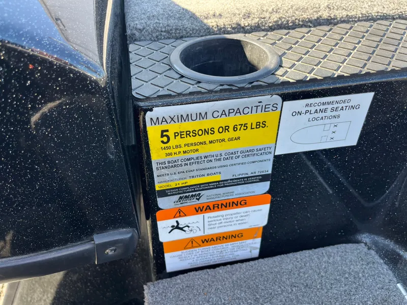 Slide: The Image of 2013 Triton 21 HP boat capacity label, max 5 persons or 675 lbs, safety warnings visible. - 63