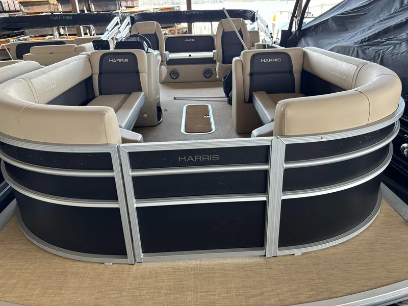 Slide: The Image of 2025 Harris CRUISER 230 SLDH pontoon boat with beige seating and sleek black exterior. - 5