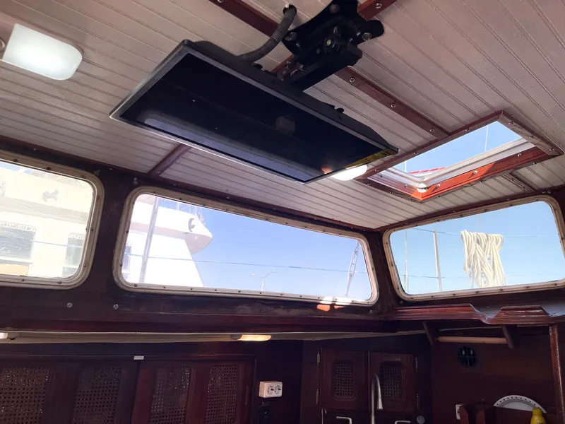 Slide: The Image of Interior view of 1983 Islander Freeport sailboat with skylights and mounted TV. - 10