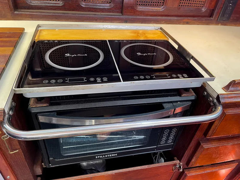 Slide: The Image of Induction cooktop and oven in 1983 Islander Freeport yacht kitchen. - 13