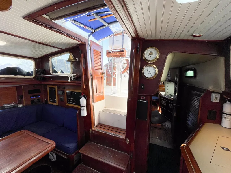 Slide: The Image of Interior of 1983 Islander Freeport sailboat with wood finish and nautical instruments. - 17