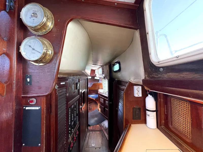 Slide: The Image of 1983 Islander Freeport yacht interior with wood paneling and nautical instruments. - 18