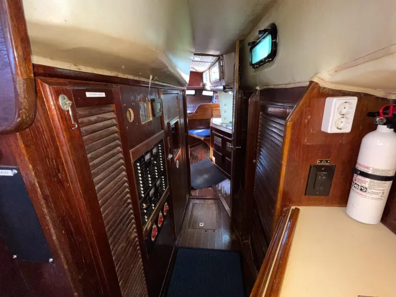 Slide: The Image of 1983 Islander Freeport yacht interior with wood paneling and electrical panel. - 19