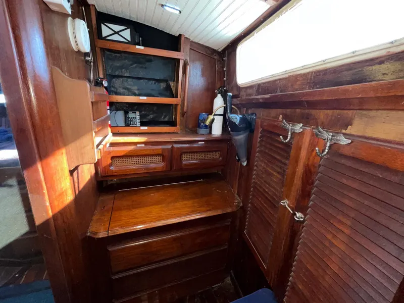 Slide: The Image of 1983 Islander Freeport cabin interior with wooden cabinetry and storage. - 23