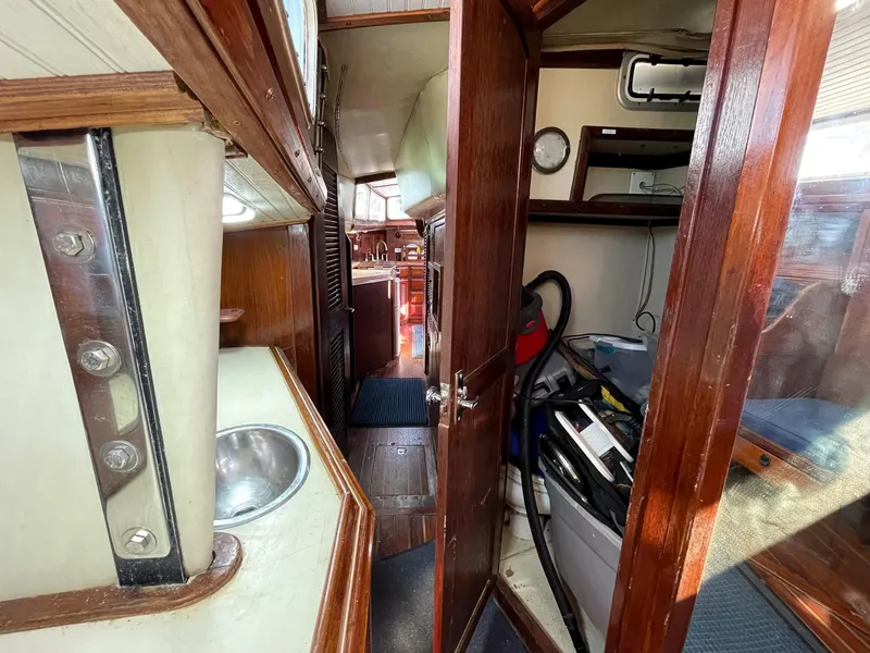 Slide: The Image of Interior of 1983 Islander Freeport sailboat with wooden cabinetry and compact layout. - 26