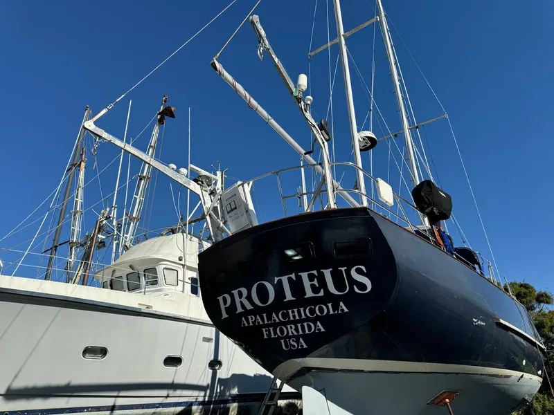 Slide: The Image of 1983 Islander Freeport sailboat "Proteus" docked in Apalachicola, Florida under clear blue sky. - 3