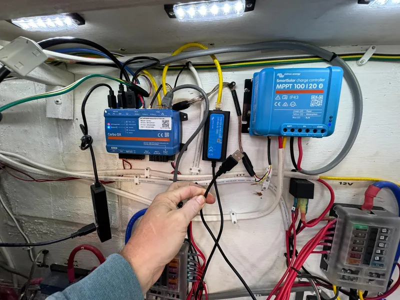 Slide: The Image of Electrical setup on 1983 Islander Freeport boat with charge controllers and wiring. - 33