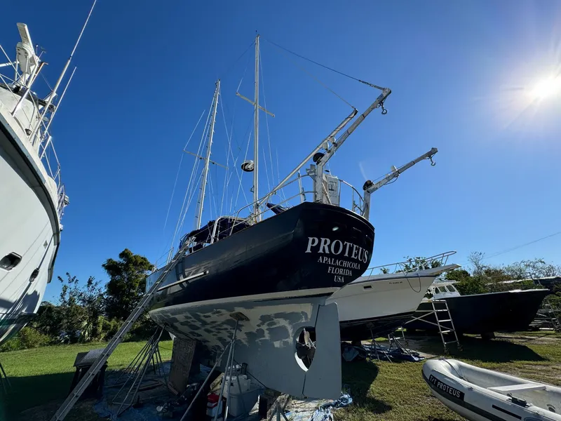 Slide: The Image of 1983 Islander Freeport sailboat "Proteus" on land, clear sky, sunny day. - 42