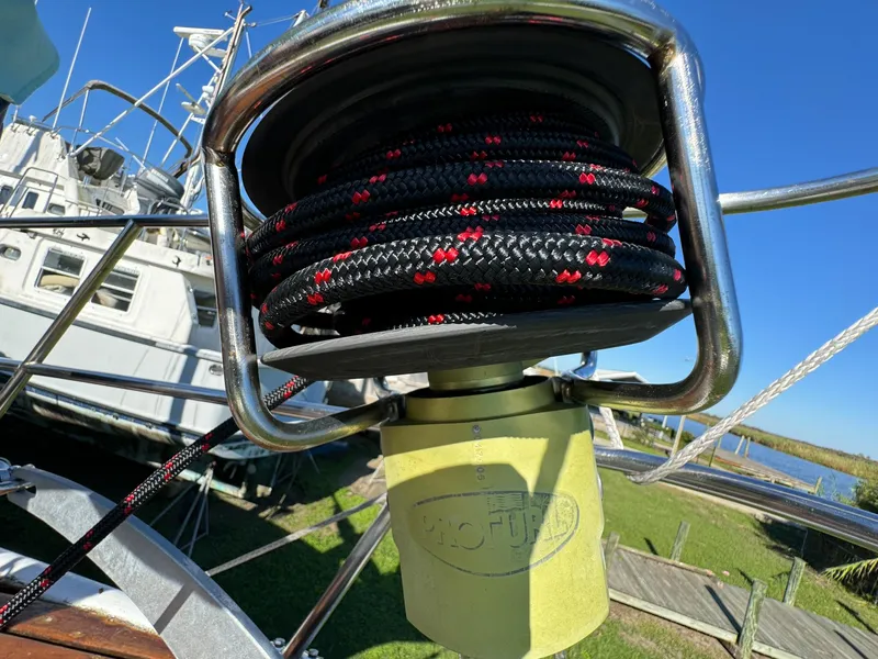 Slide: The Image of Close-up of a 1983 Islander Freeport sailboat winch with coiled rope. - 47