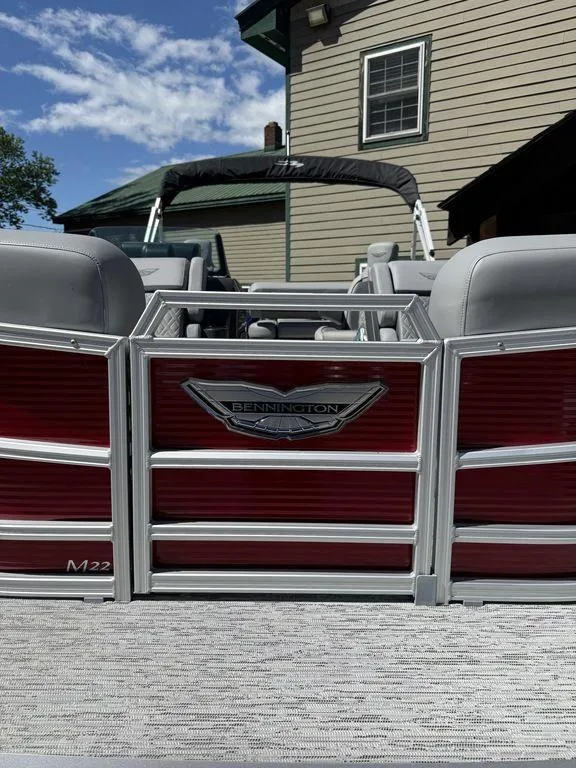 Slide: The Image of 2025 Bennington 22 MSB pontoon boat with red paneling and gray seating. - 1